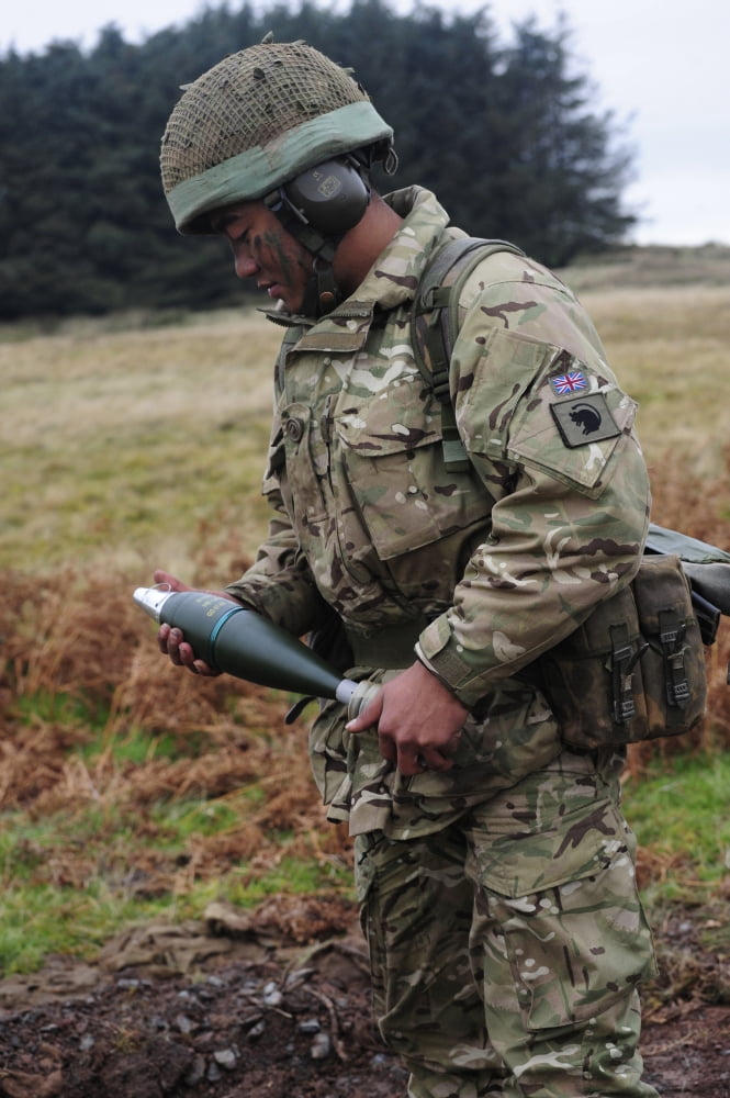 A Gurkha soldier holding a 81mm high-explosive mortar round Canvas Art - Andrew ChittockStocktrek Images (23 x 35)