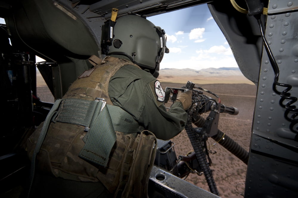 A HH-60G Pave Hawk gunner fires his GAU-17 machine gun Canvas Art - Erik RoelofsStocktrek Images (35 x 23)