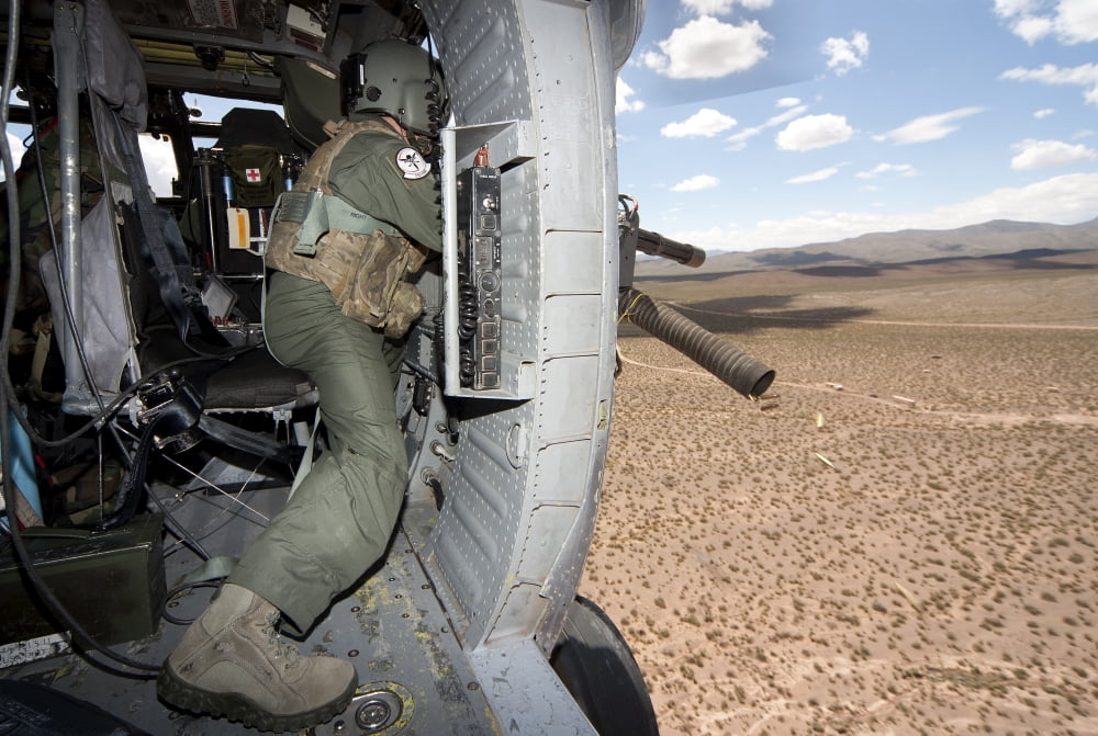 A HH-60G Pave Hawk gunner fires his GAU-17 machine gun Canvas Art - Erik RoelofsStocktrek Images (35 x 23)