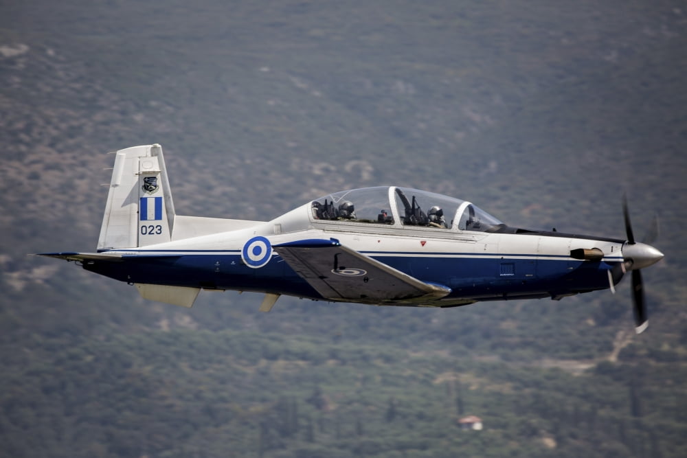 A Hellenic Air Force T-6 trainer flying over Kalamata Greece Canvas Art - Timm ZiegenthalerStocktrek Images (34 x 23)