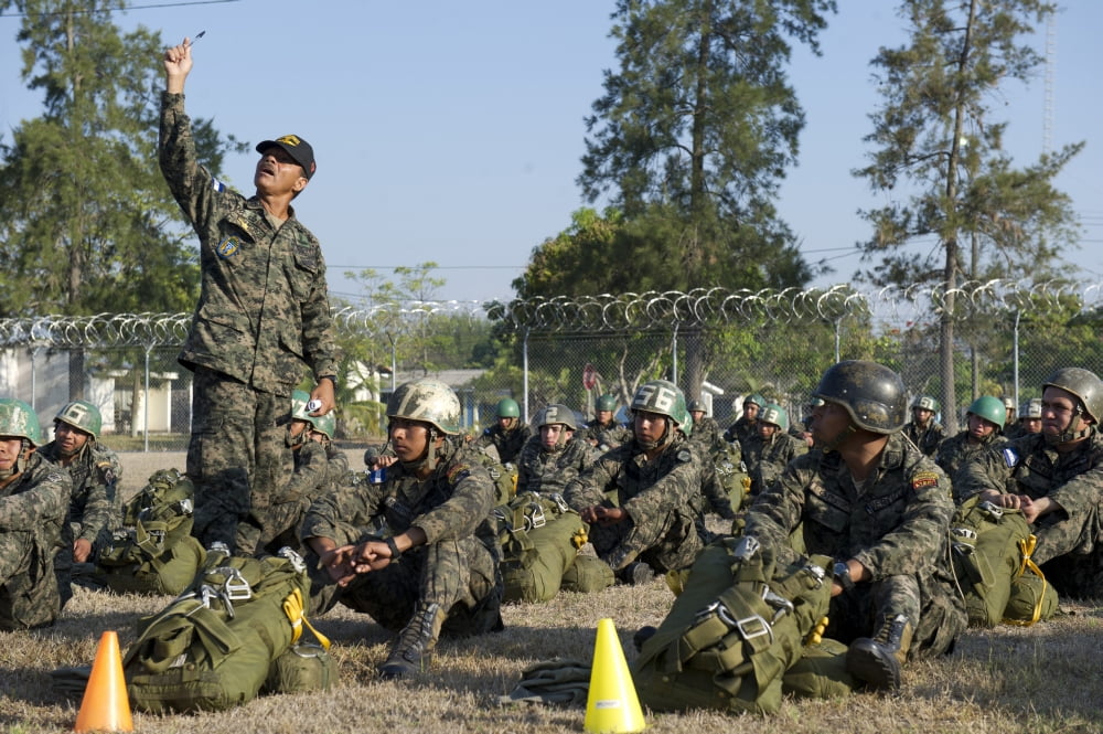 A Honduran Jumpmaster explains actions to conduct during a static line jump Canvas Art - Stocktrek Images (34 x 23)