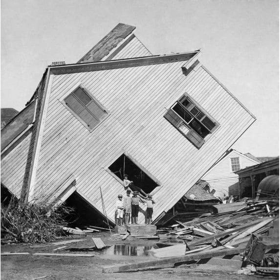 A House Tipped On Side After The 15 Foot Storm Surge Of The Galveston Hurricane Of Sept. 1900. Five Boys Pose In Front