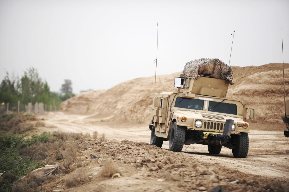 A Humvee conducts security during a patrol in the Iraqi village of Bakr Canvas Art - Stocktrek Images (34 x 23)