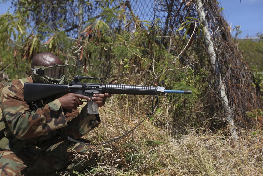 A Jamaican soldier scans through the foliage Canvas Art - Stocktrek Images (34 x 23)