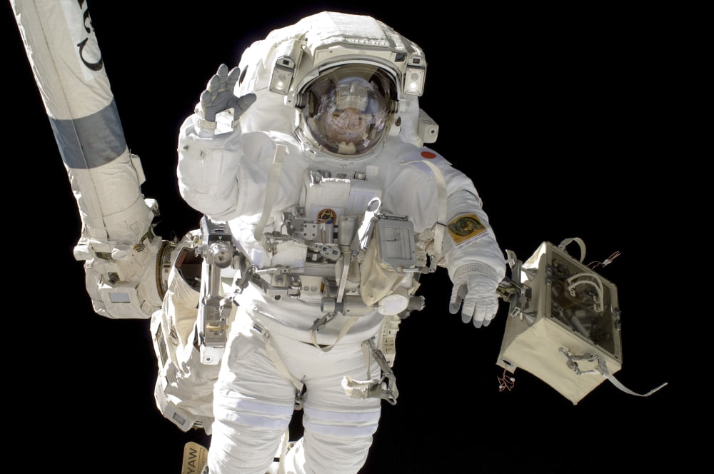 A Japan Aerospace Exploration Agency astronaut anchored to a foot restraint Canvas Art - Stocktrek Images (35 x 23)