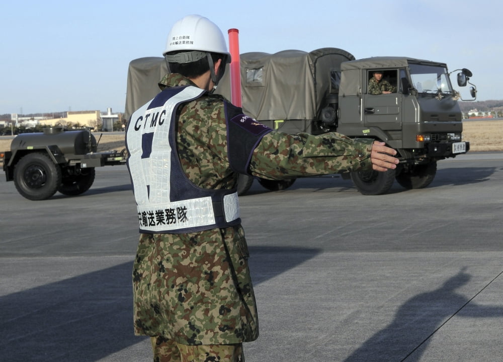 A Japanese soldier marshals vehicles from a C-17 Globemaster III Canvas Art - Stocktrek Images (34 x 24)