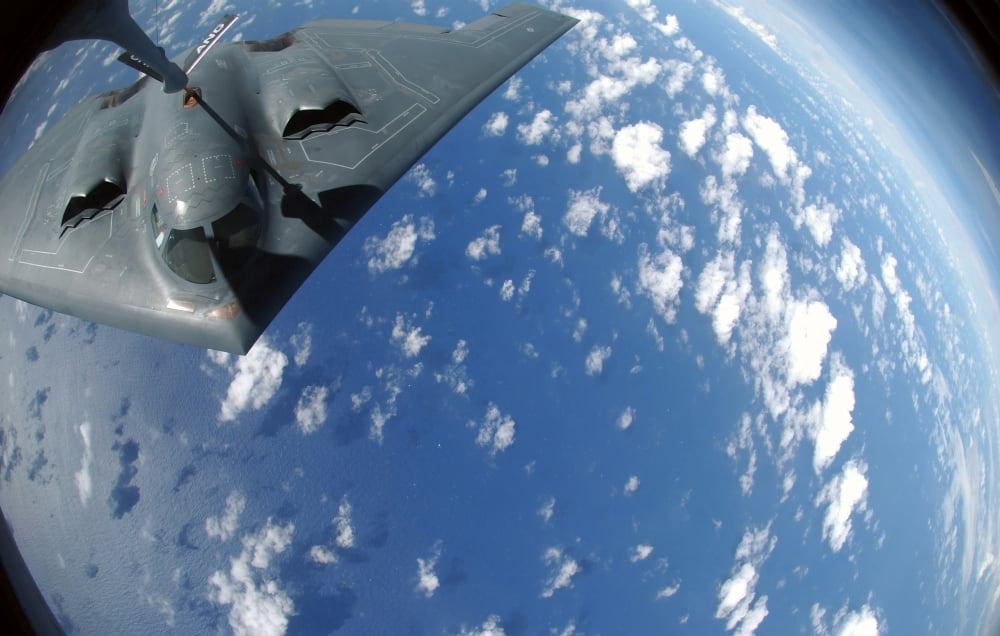 A KC-135 Stratotanker refuels a B-2 Spirit over the Pacific Ocean Canvas Art - Stocktrek Images (35 x 22)