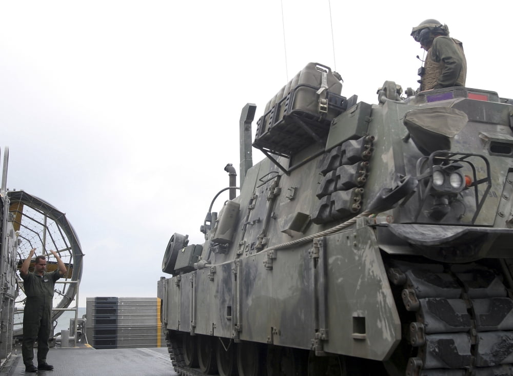 A Landing Craft Air-Cushioned loadmaster signals the crew of an M88A2 Hercules Recovery Vehicle Canvas Art - Stocktrek Images (32 x 24)