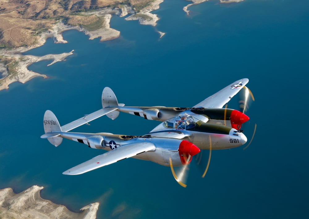 A Lockheed P-38 Lightning fighter aircraft in flight Canvas Art - Scott GermainStocktrek Images (17 x 12)