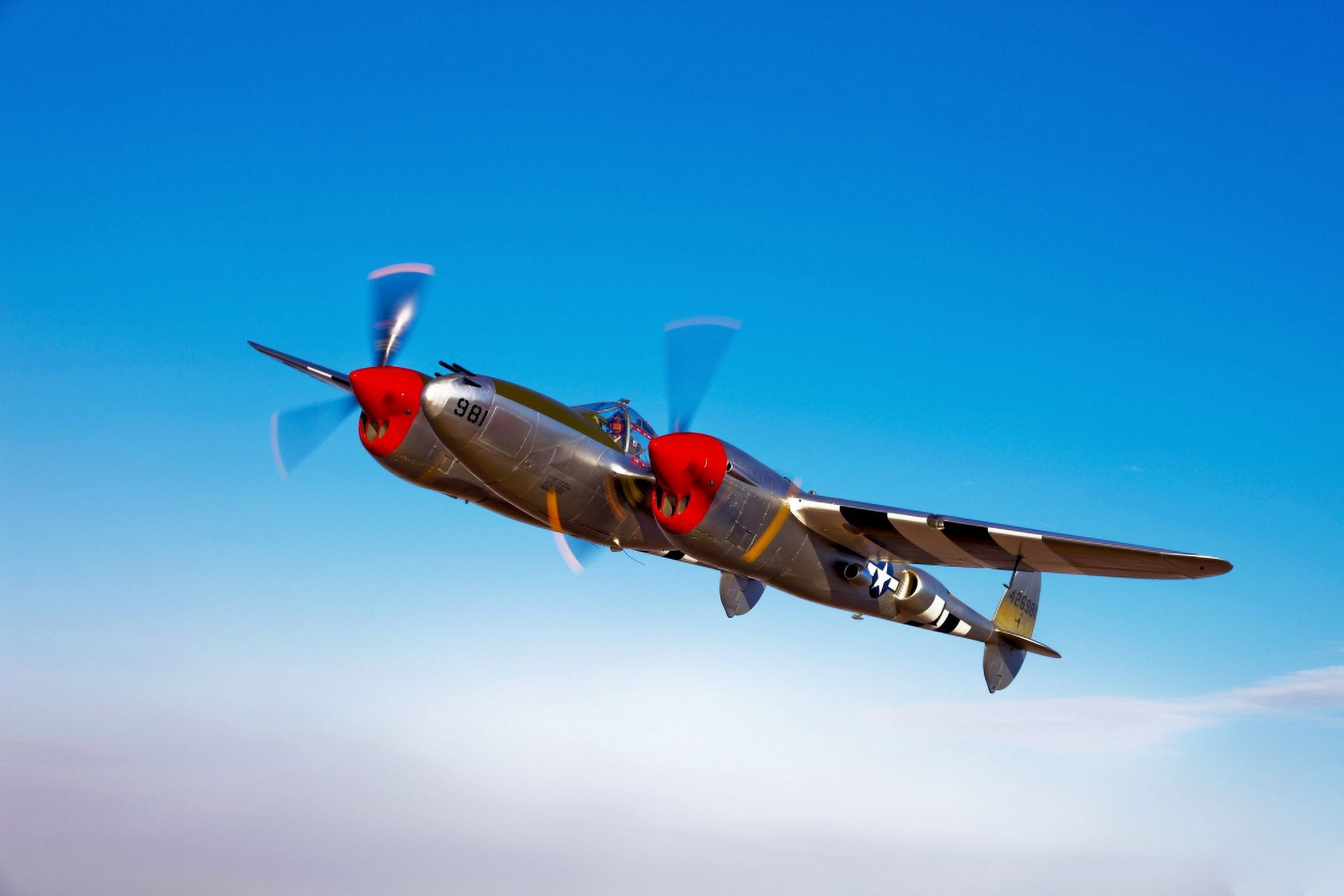 A Lockheed P-38 Lightning fighter aircraft in flight Canvas Art - Scott GermainStocktrek Images (35 x 23)