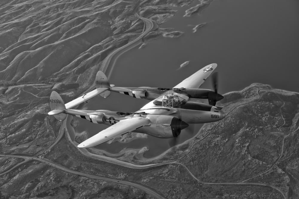 A Lockheed P-38 Lightning fighter aircraft in flight Canvas Art - Scott GermainStocktrek Images (35 x 23)