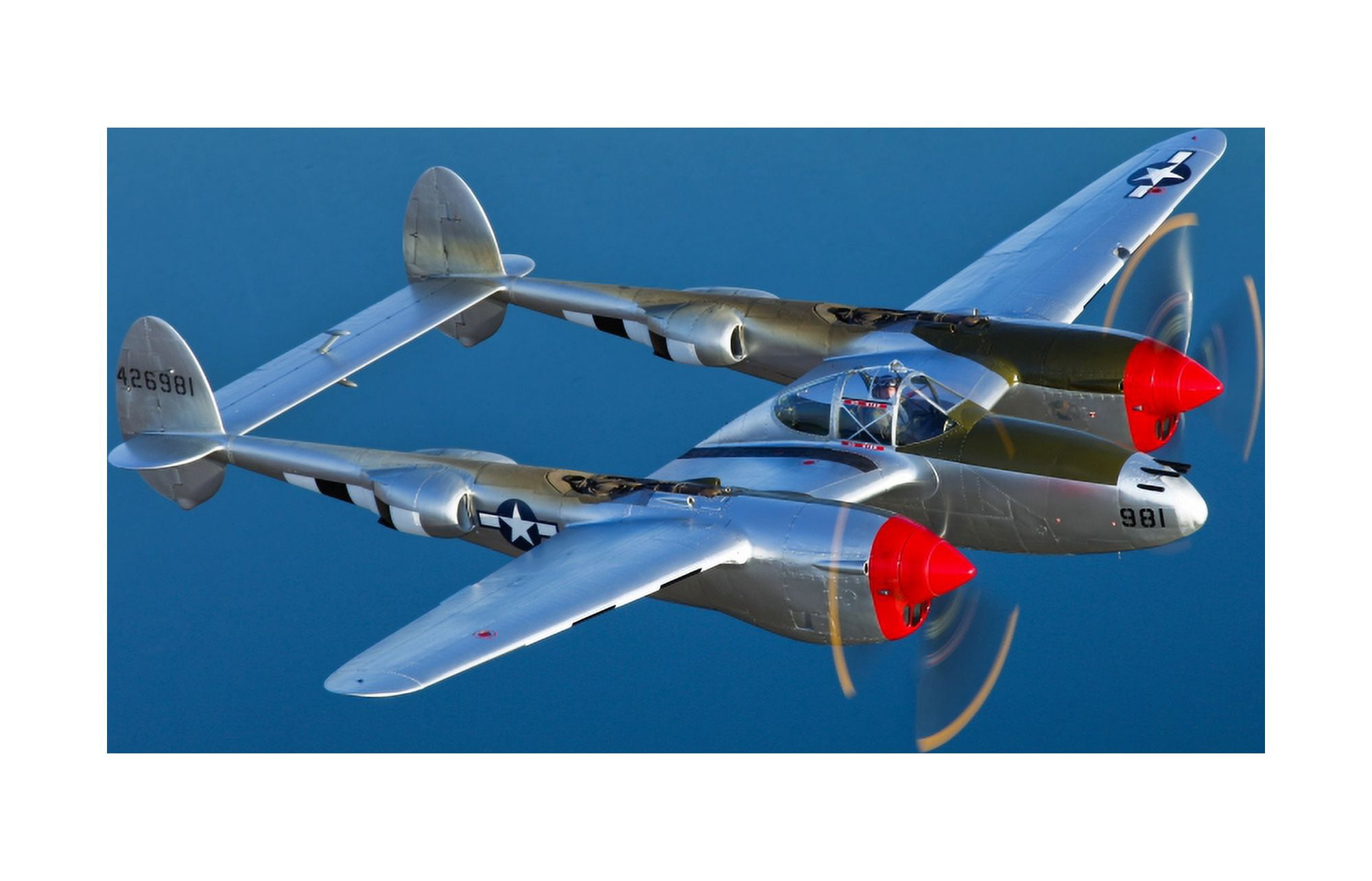 A Lockheed P-38 Lightning fighter aircraft in flight Canvas Art - Scott GermainStocktrek Images (35 x 23)