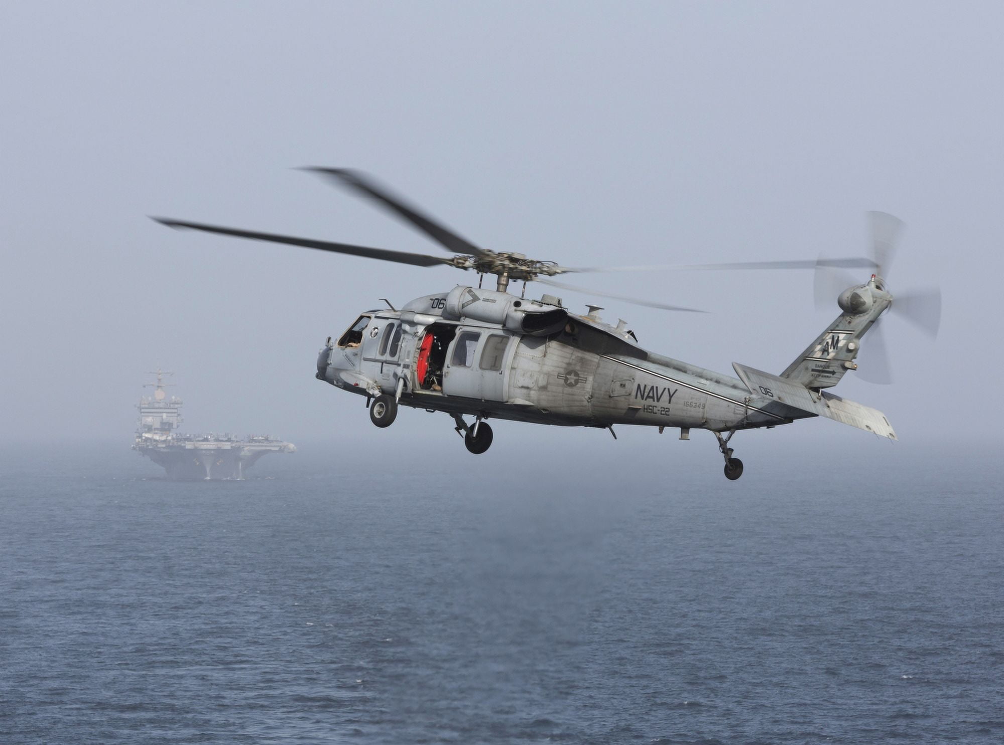 A MH-60S Knighthawk conducts a vertical replenishment at sea Canvas Art - Gert KromhoutStocktrek Images (33 x 24)