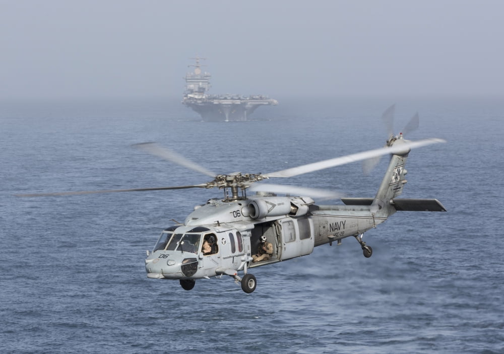 A MH-60S Knighthawk conducts a vertical replenishment at sea Canvas Art - Gert KromhoutStocktrek Images (34 x 24)