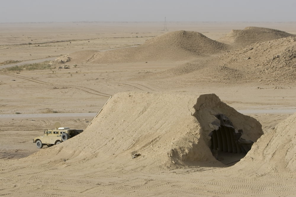 A Mamba armored vehicle sits in front of a Iraqi Magazine that has been hit by a coalition bomb Canvas Art - Terry MooreStocktrek Images (34 x 23)