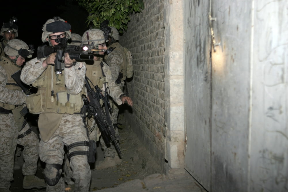 A Marine aims his rifle as he prepares to bust into a house Canvas Art - Stocktrek Images (34 x 23)