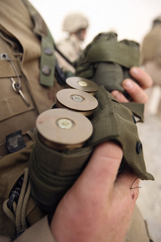 A Marine cradles handfuls of 40 mm grenades Canvas Art - Stocktrek Images (23 x 35)