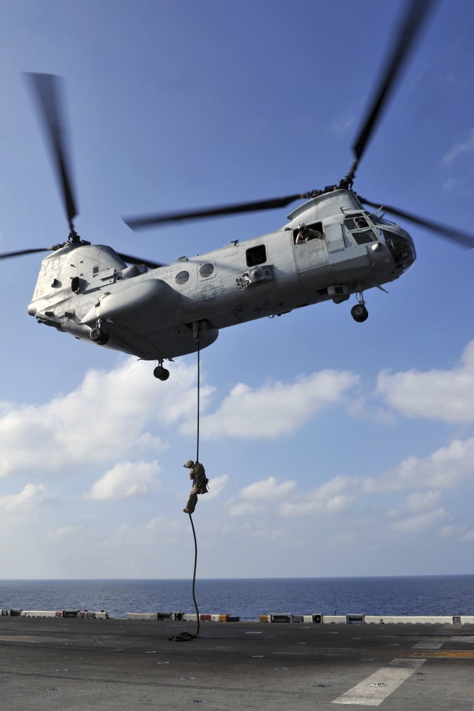 A Marine fast ropes from a CH-46E Sea Knight helicopter Canvas Art - Stocktrek Images (23 x 35)