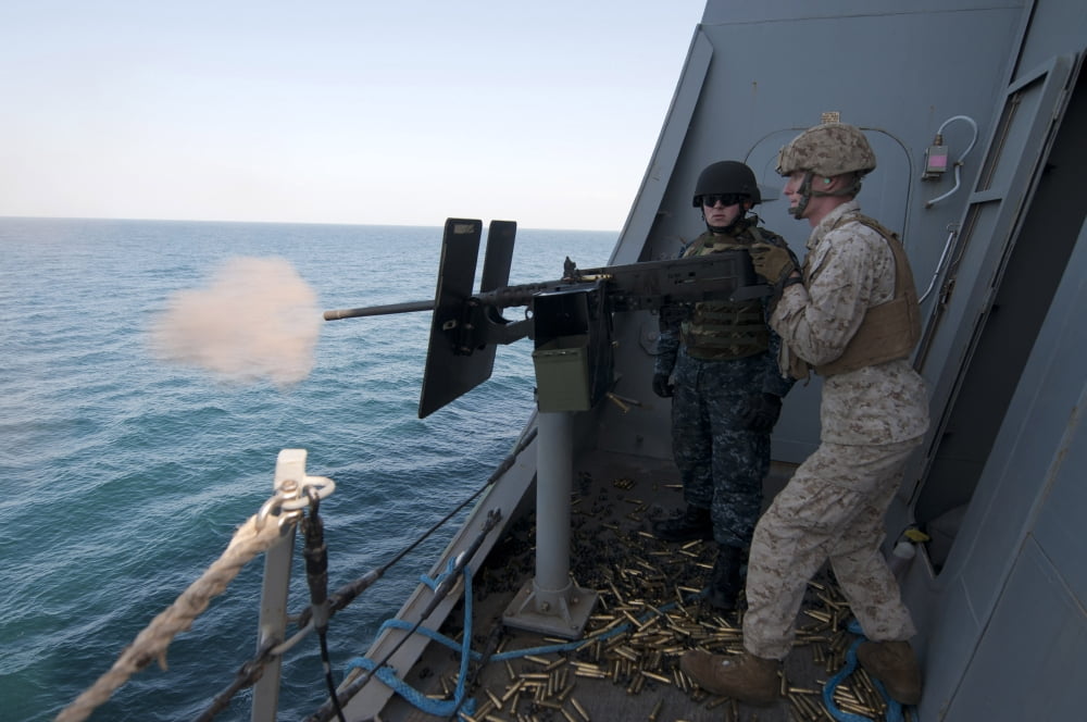 A Marine fires a 50-caliber machine gun aboard USS New Orleans Canvas Art - Stocktrek Images (35 x 23)