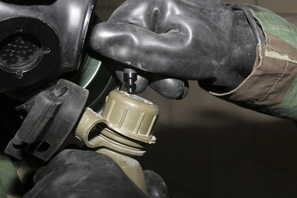 A Marine inserts a drinking tube into his canteen Canvas Art - Stocktrek Images (34 x 23)