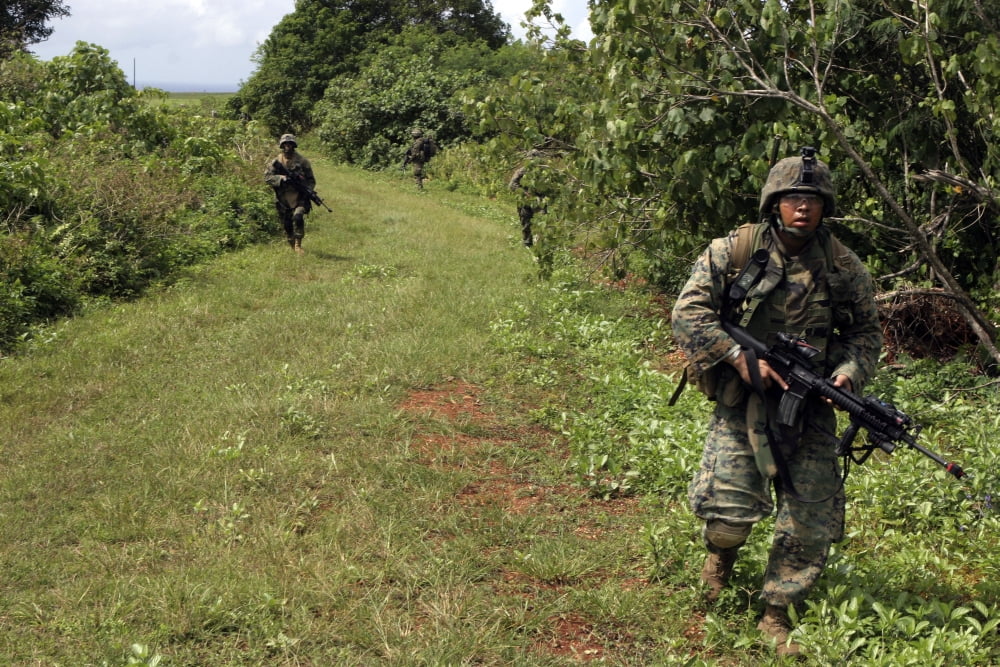 A Marine leads the way on a patrol through the jungles of Guam Canvas Art - Stocktrek Images (34 x 23)