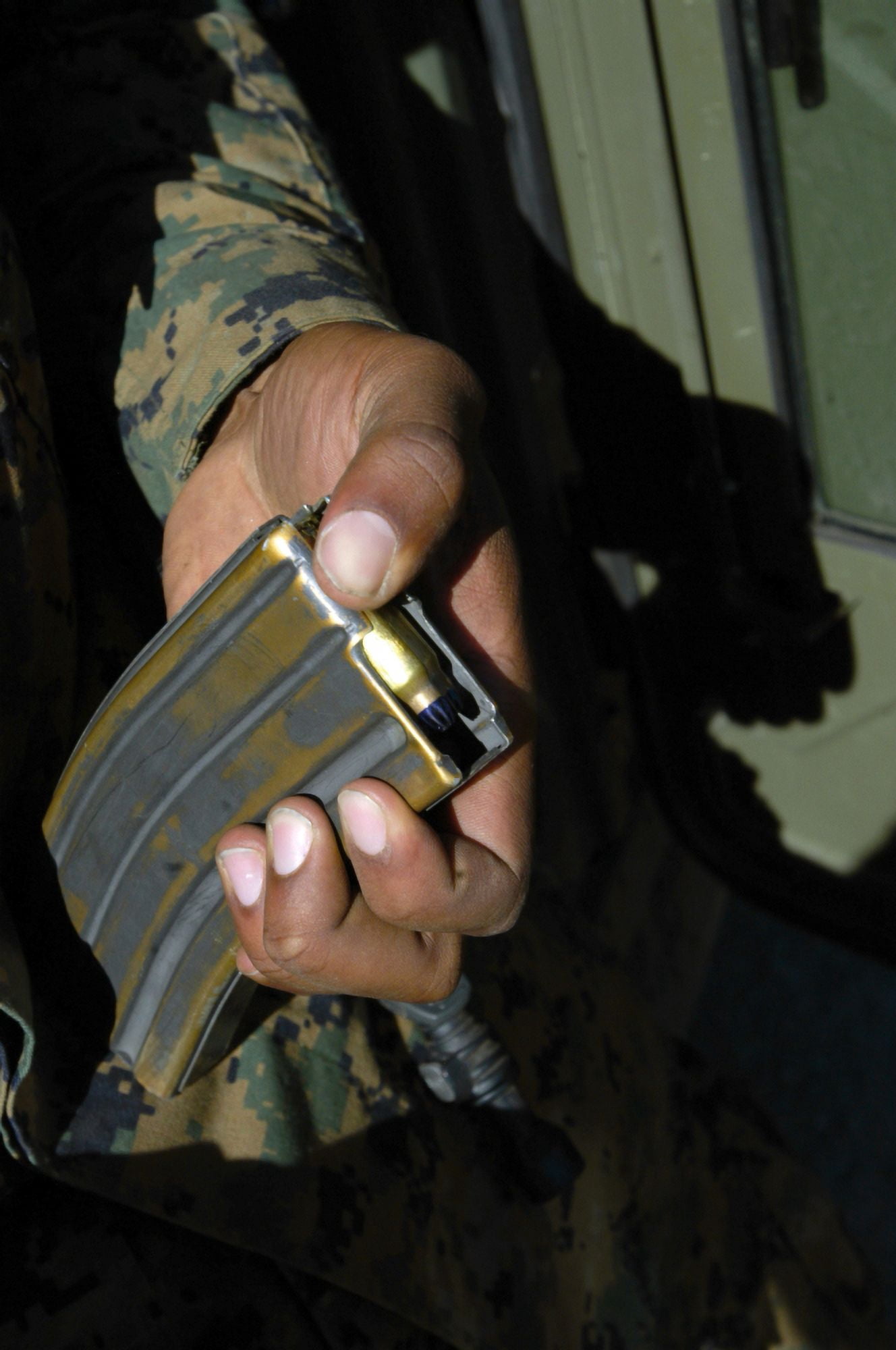 A Marine loads blank ammunition rounds into a magazine Canvas Art - Stocktrek Images (23 x 34)