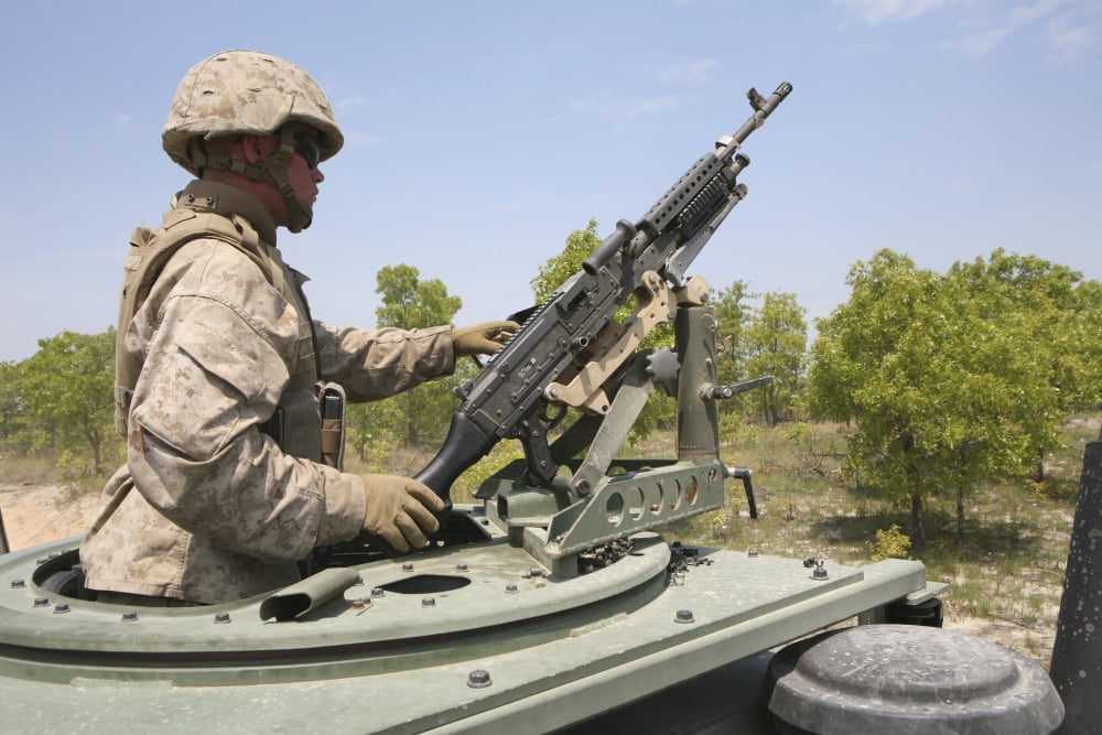 A Marine prepares to fire his M240 machine gun while riding in a vehicle turret Canvas Art - Stocktrek Images (34 x 23)