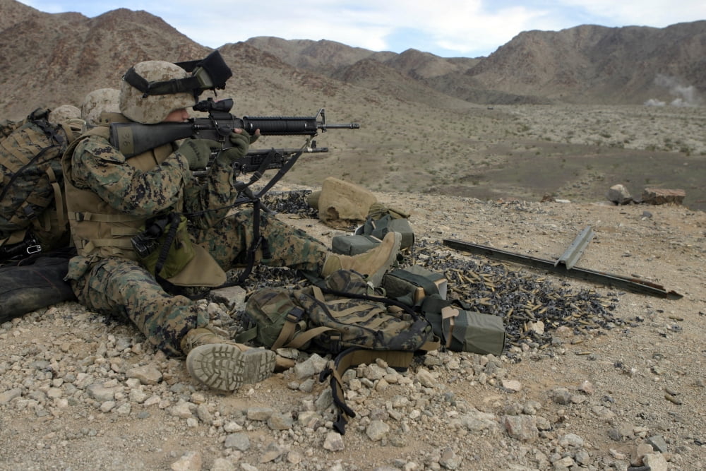 A Marine rifleman provides security for machine gunners atop a hill Canvas Art - Stocktrek Images (34 x 23)