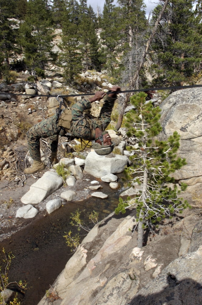 A Marine works his way across a one-rope bridge spanning a small gorge Canvas Art - Stocktrek Images (23 x 34)