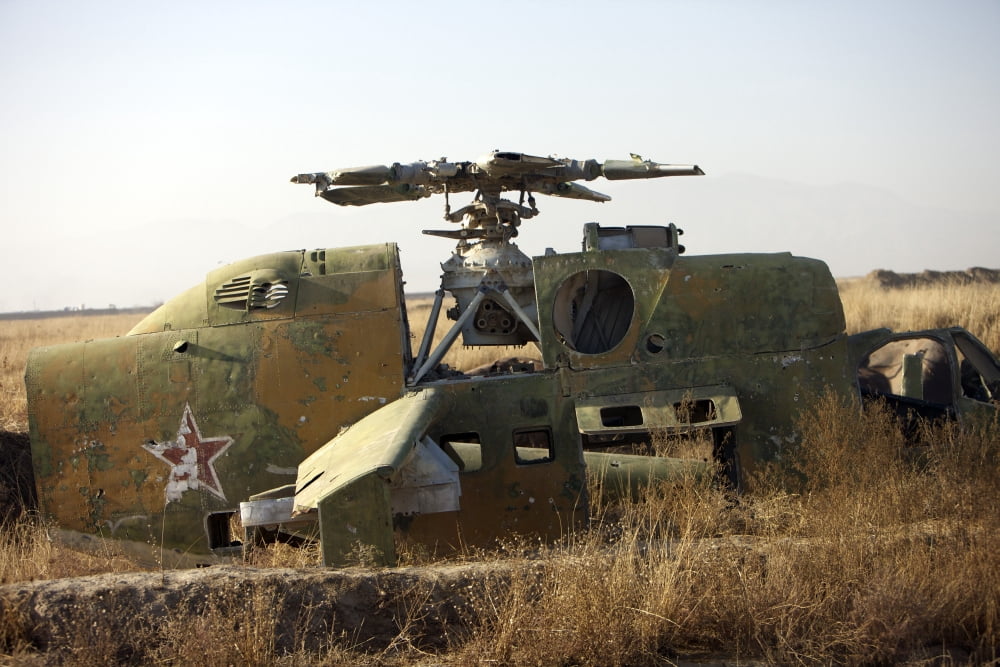 A Mi-35 attack helicopter at Kunduz Air Field Northern Afghanistan Canvas Art - Terry MooreStocktrek Images (18 x 12)