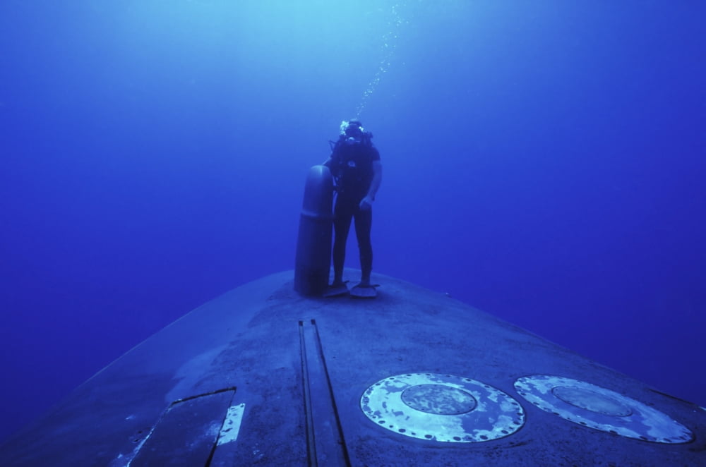 A Navy SEAL stands next to the sonar dome on the bow of the USS Kamehameha Canvas Art - Michael WoodStocktrek Images (18 x 12)