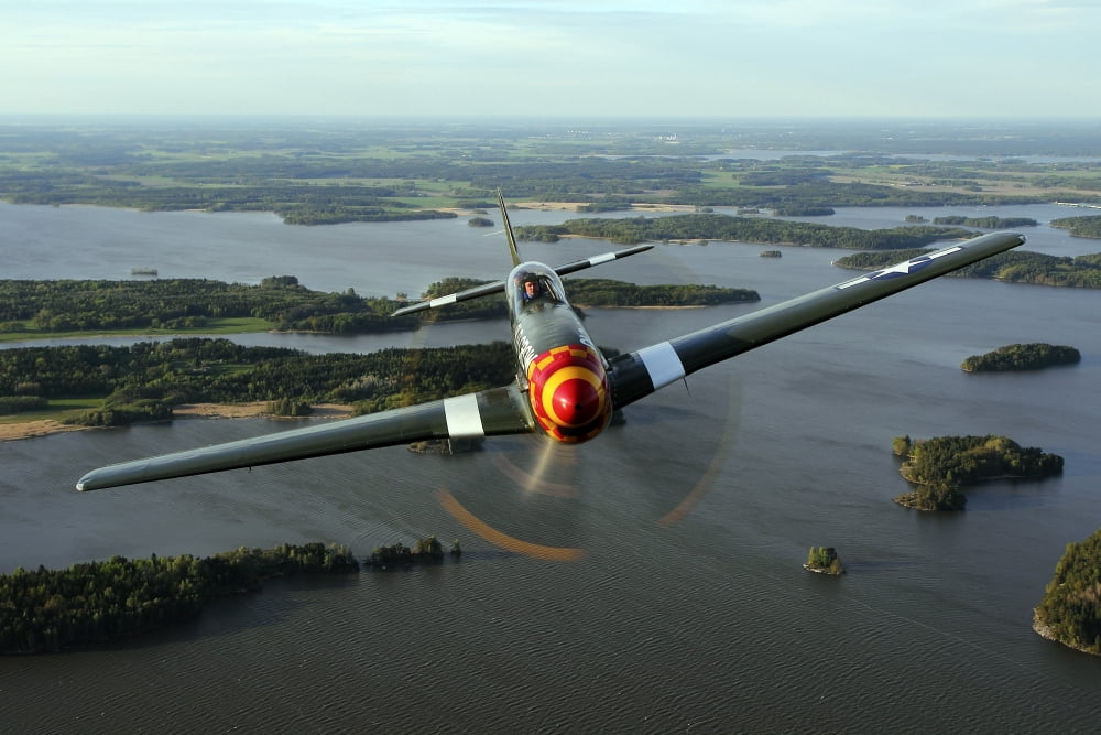 A North American P-51 Mustang in flight over Vasteras Sweden Canvas Art - Daniel KarlssonStocktrek Images (35 x 23)
