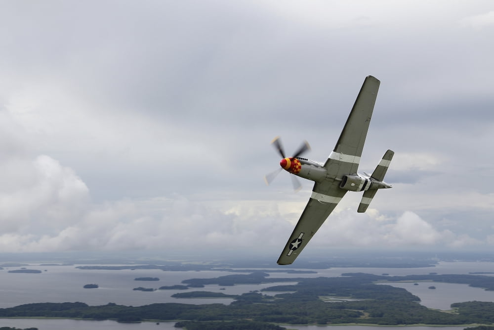 A North American P-51 Mustang in flight over Vasteras Sweden Canvas Art - Daniel KarlssonStocktrek Images (35 x 23)