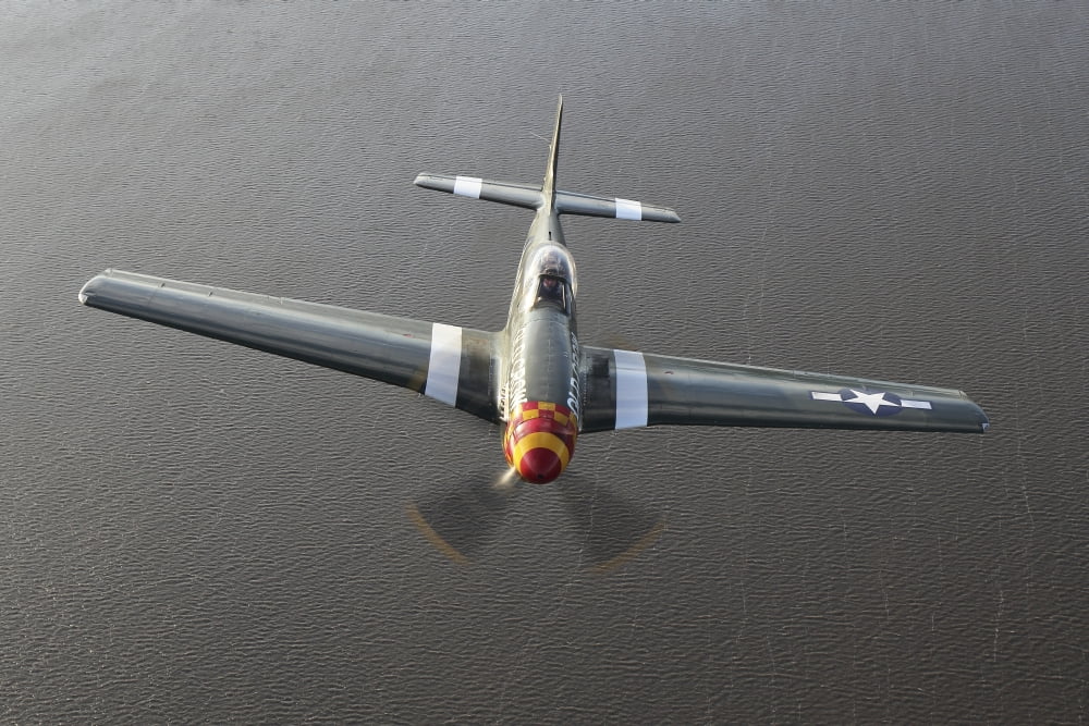 A North American P-51 Mustang in flight over Vasteras Sweden Canvas Art - Daniel KarlssonStocktrek Images (35 x 23)