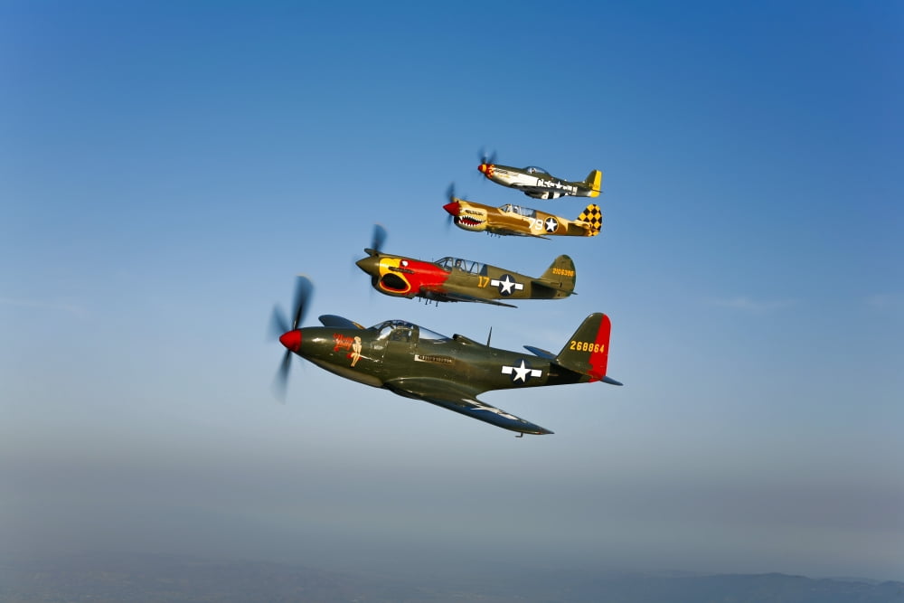 A P-36 Kingcobra two Curtiss P-40N Warhawks and a P-51D Mustang in flight Canvas Art - Scott GermainStocktrek Images (18 x 12)