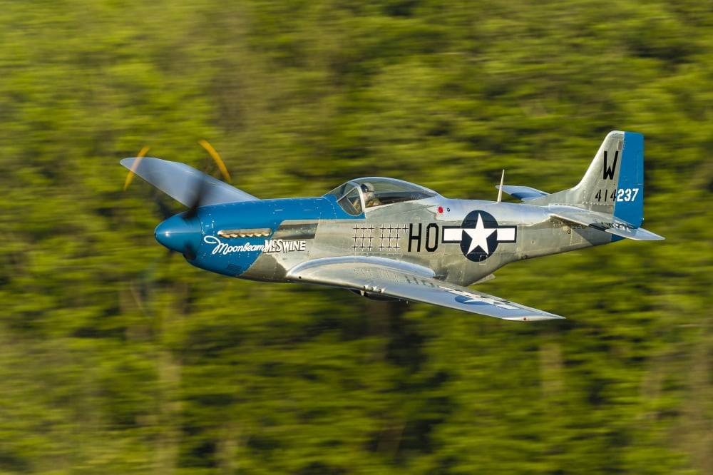 A P-51 Mustang flies along the Mississippi at Dubuque Iowa Canvas Art - Rob EdgcumbeStocktrek Images (17 x 12)
