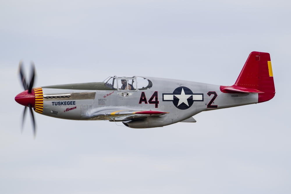 A P-51 Mustang flies by at EAA Airventure Oshkosh Wisconsin Canvas Art - Rob EdgcumbeStocktrek Images (34 x 23)