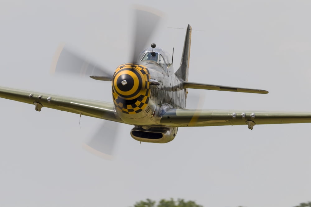 A P-51 Mustang flies by at East Troy Wisconsin Canvas Art - Rob EdgcumbeStocktrek Images (17 x 12)