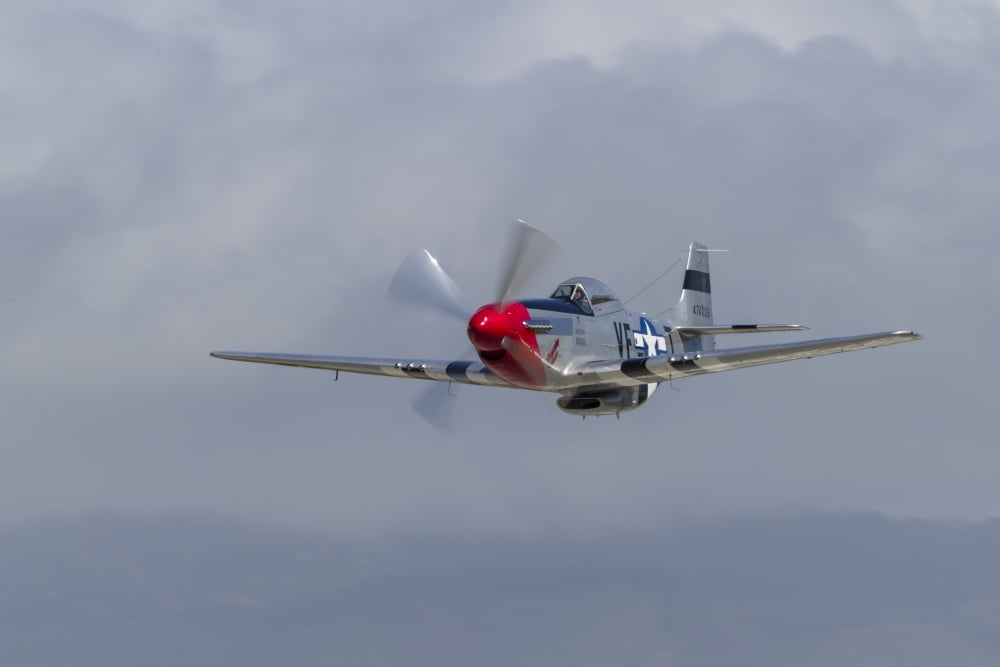 A P-51 Mustang flies by at Half Moon Bay California Canvas Art - Rob EdgcumbeStocktrek Images (17 x 12)