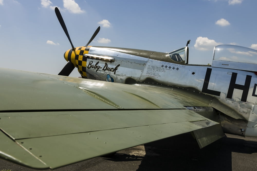 A P-51 Mustang parked on the ramp at East Troy Wisconsin Canvas Art - Rob EdgcumbeStocktrek Images (34 x 23)