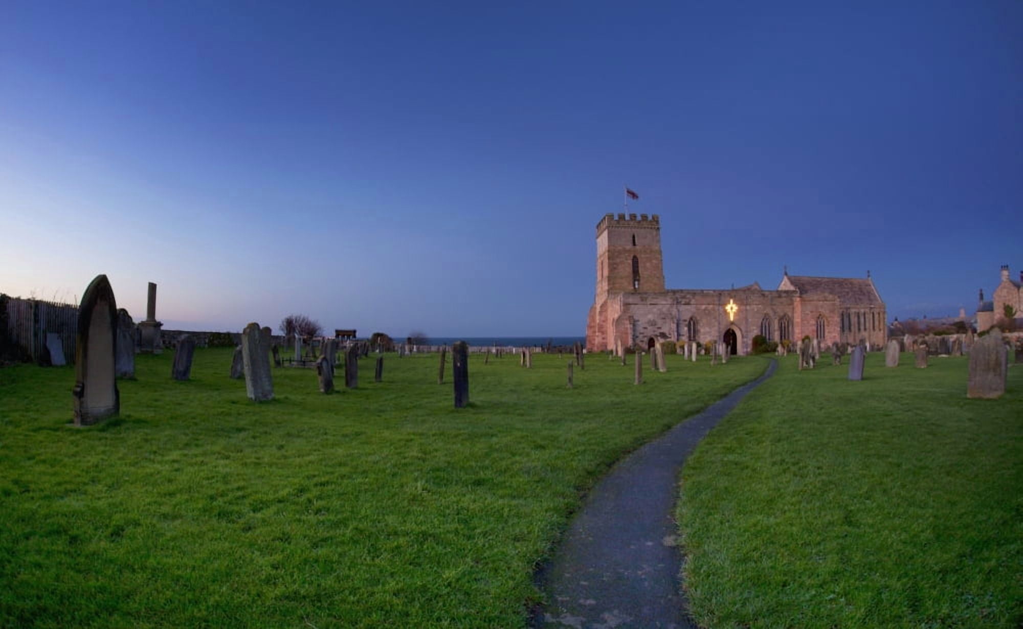 A Path Leading Through A Cemetery To A Church Building Bamburgh Northumberland England Canvas Art - John Short Design Pics (19 x 12)