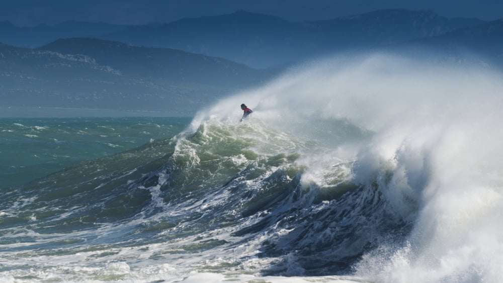 A Person Surfing In The Waves Along The Coast Of Cape Trafalgar Cadiz Andalusia Spain Canvas Art - Ben Welsh Design Pics (20 x 11)