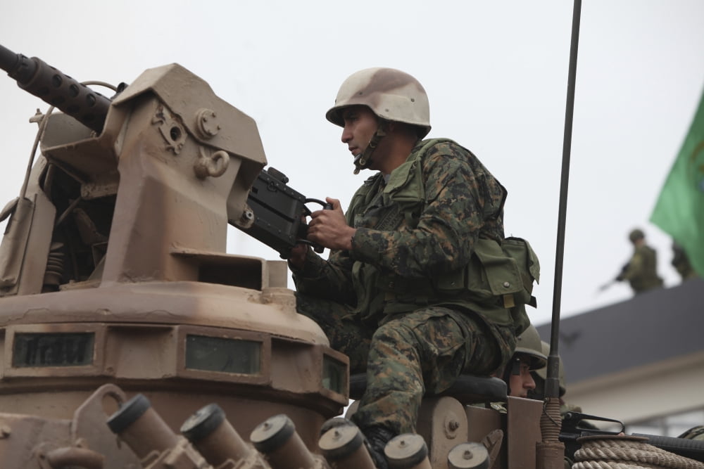 A Peruvian marine sits behind a 50 caliber machine gun Canvas Art - Stocktrek Images (34 x 23)
