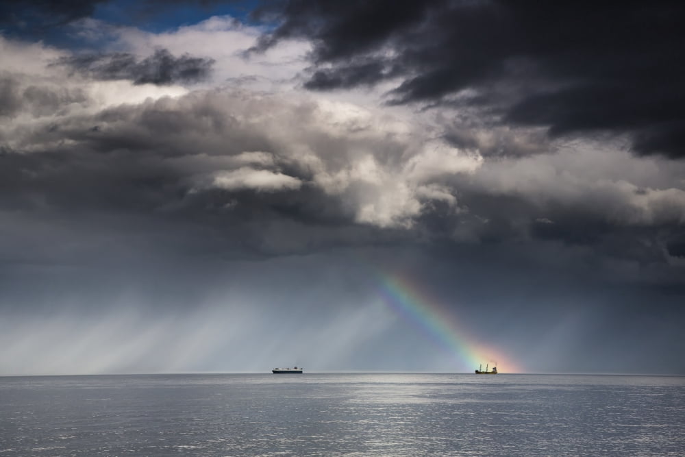 A Rainbow Through Storm Clouds Over An Ocean With Two Ships Whitley Bay Northumberland England Canvas Art - John Short Design Pics (38 x 24)