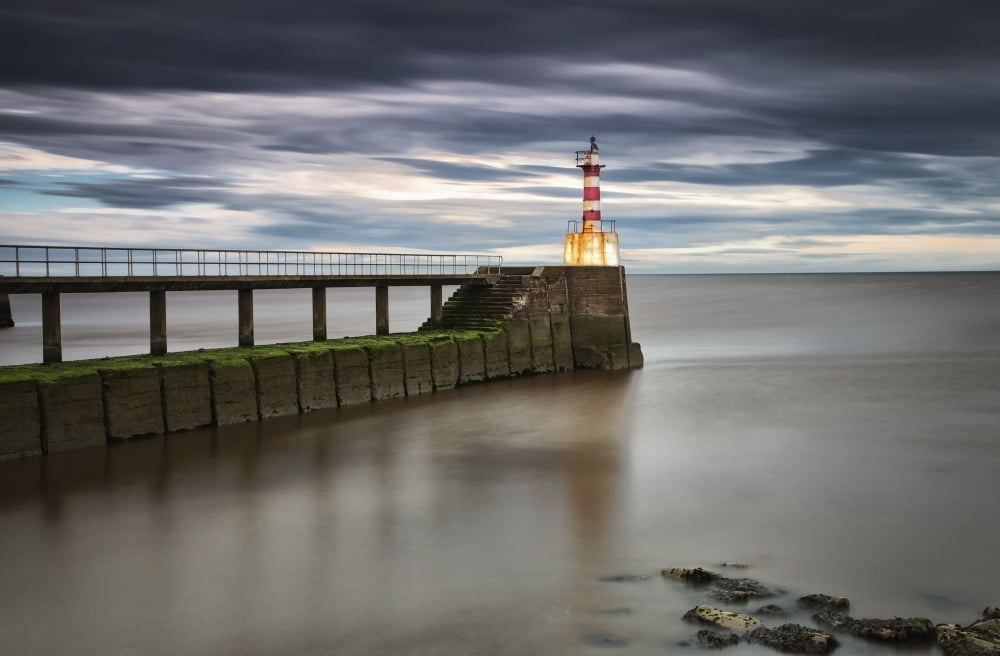 A Red And White Striped Lighthouse At The End Of A Pier Amble Northumberland England Canvas Art - John Short Design Pics (38 x 24)