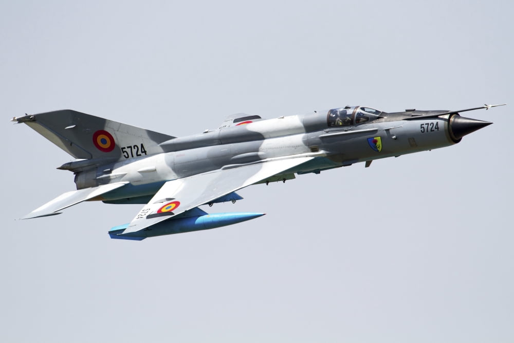 A Romanian Air Force MiG-21 Lancer over Romania Canvas Art - Anton BalakchievStocktrek Images (35 x 23)