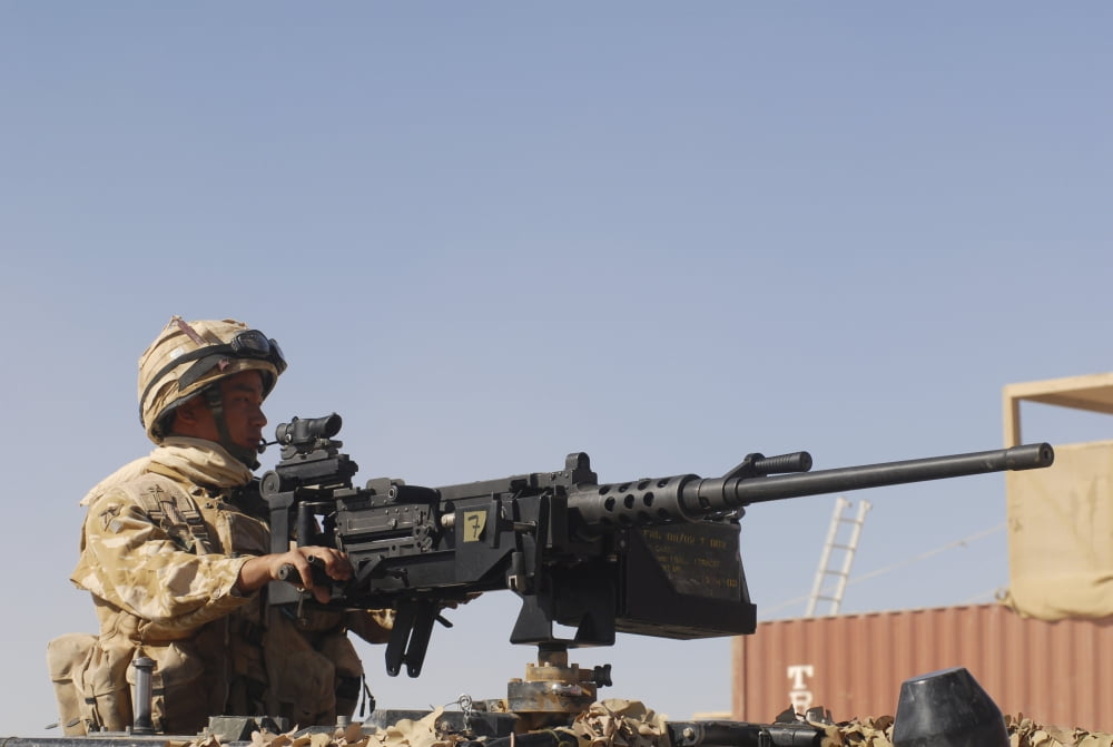 A Royal Marine manning a 50 caliber machine gun Canvas Art - Andrew ChittockStocktrek Images (17 x 12)