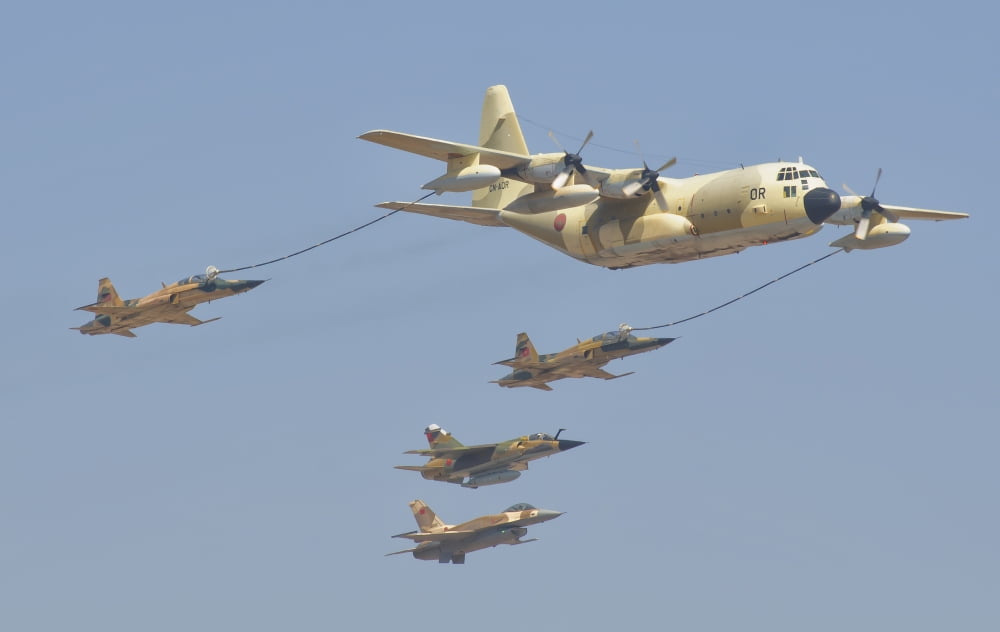 A Royal Moroccan Air Force KC-130 refueling a pair of F-5 aircraft Canvas Art - Giovanni CollaStocktrek Images (36 x 23)