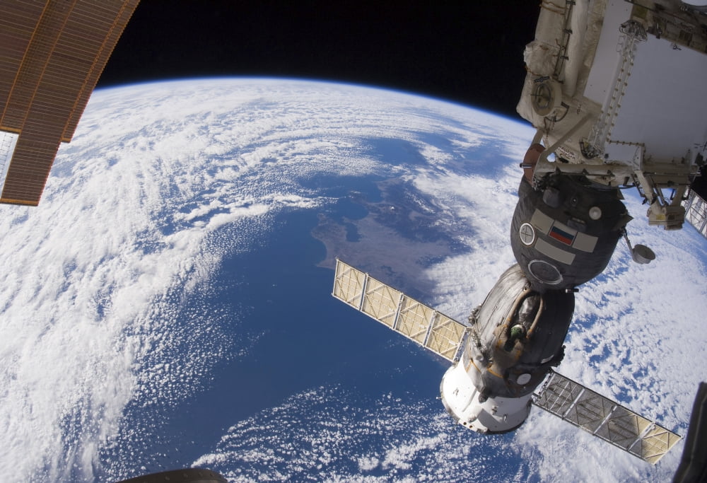 A Russian Soyuz spacecraft docked to the International Space Station Canvas Art - Stocktrek Images (34 x 24)