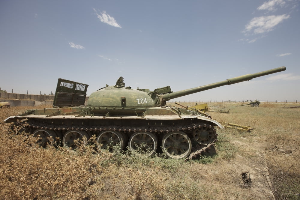A Russian T-62 main battle tank rests in an armor junkyard Canvas Art - Terry MooreStocktrek Images (18 x 12)